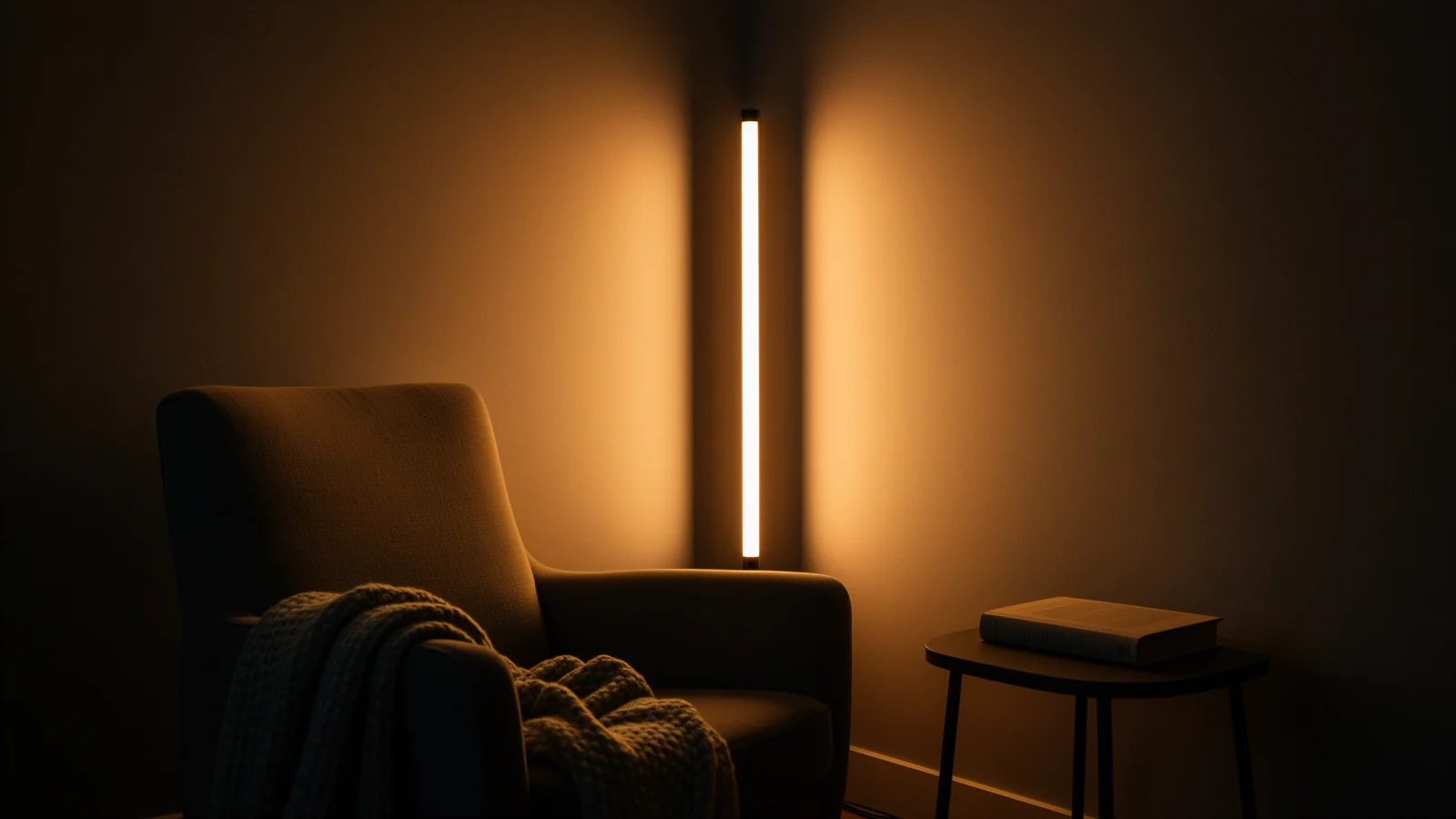 Floor-standing LED strip washing a corner wall in warm white